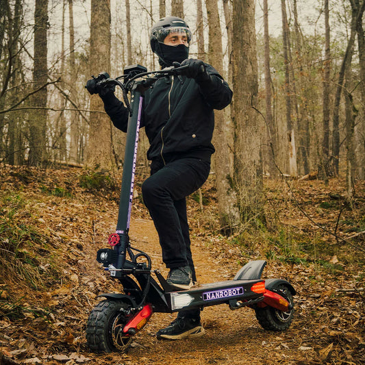 Person riding an electric scooter in a forest