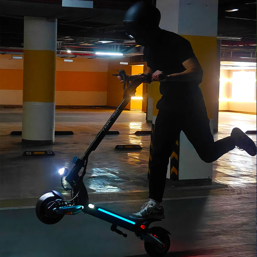 Person riding an electric scooter in a parking garage