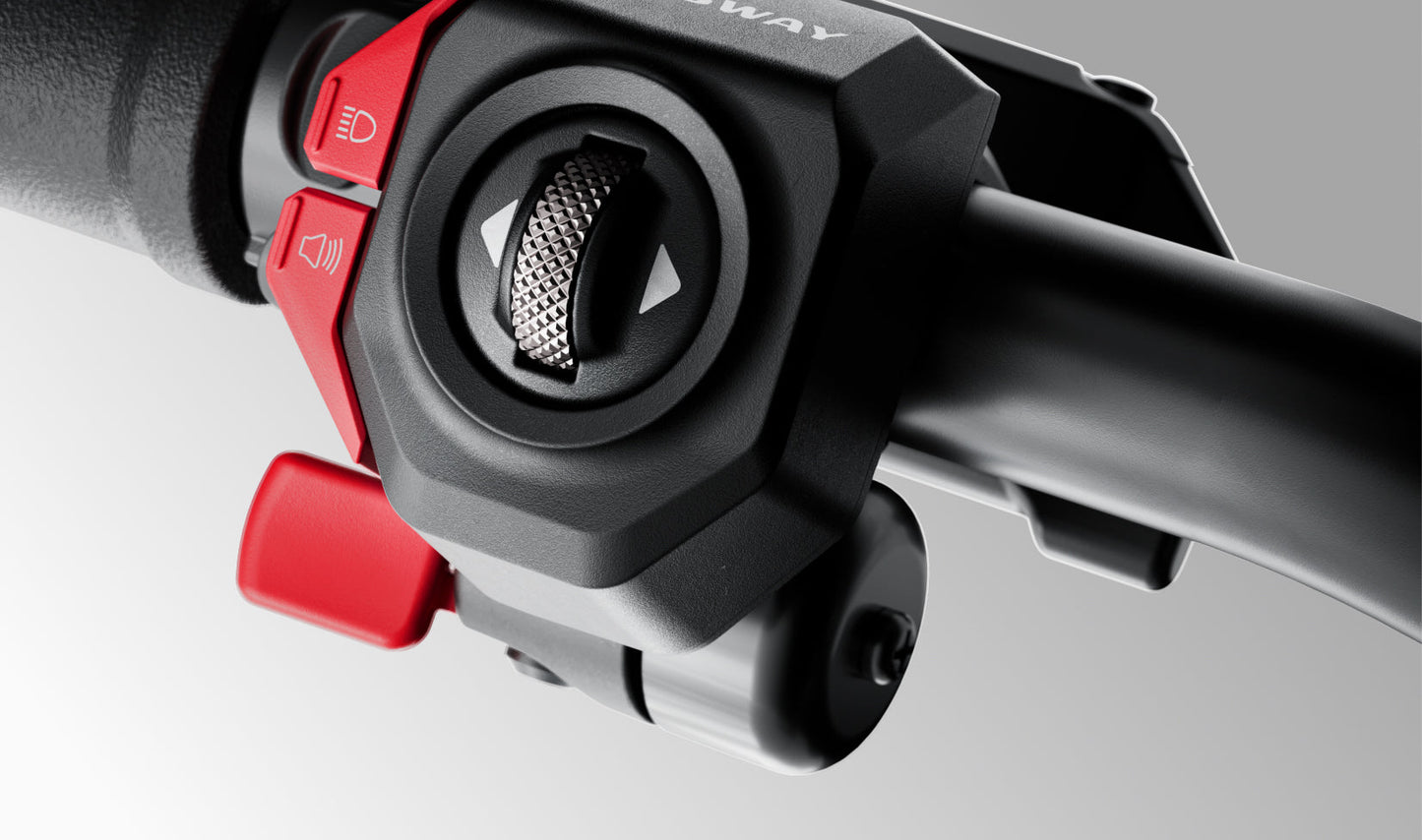 Close-up of a motorcycle handlebar with control buttons on a gray background