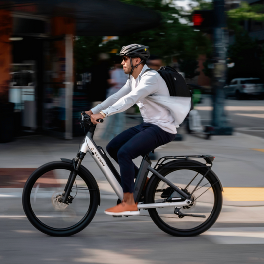 Person riding a bicycle on a city street with blurred background