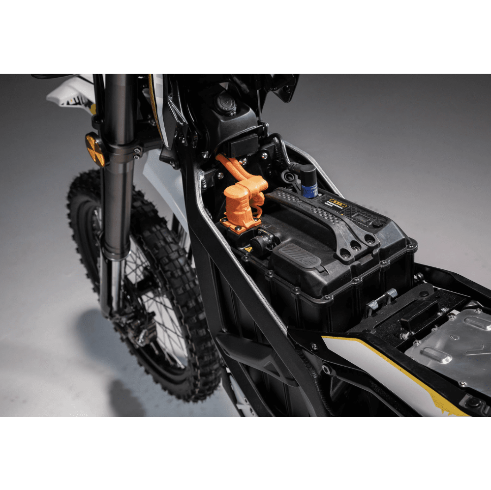 Close-up of a dirt bike's suspension and frame on a gray background