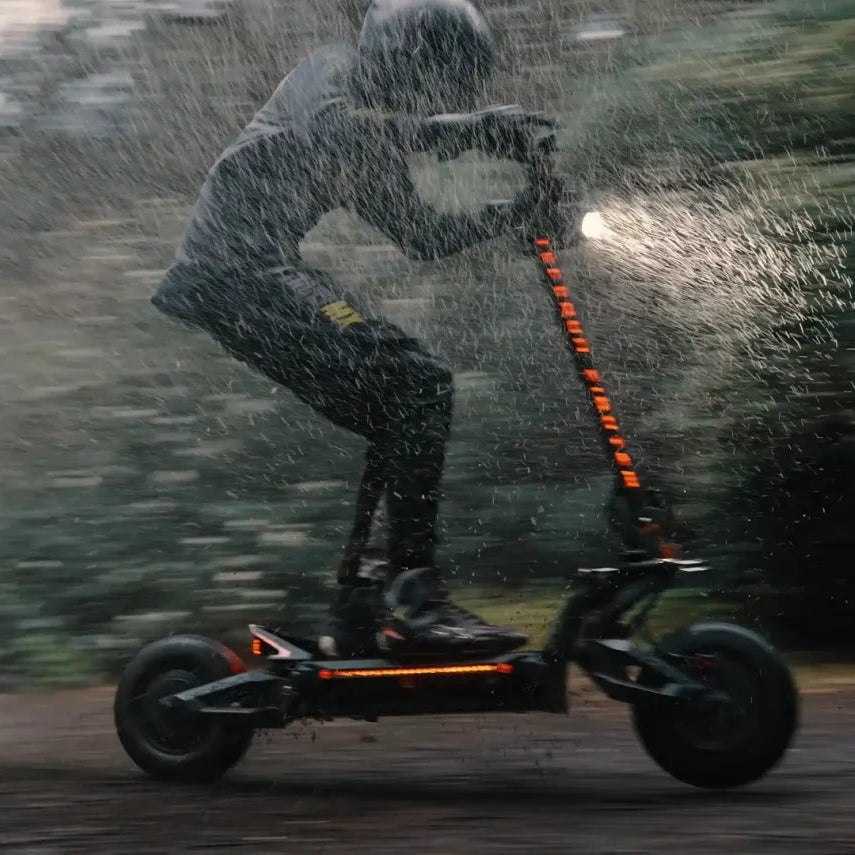 Person riding a hoverboard in the rain with a blurred background